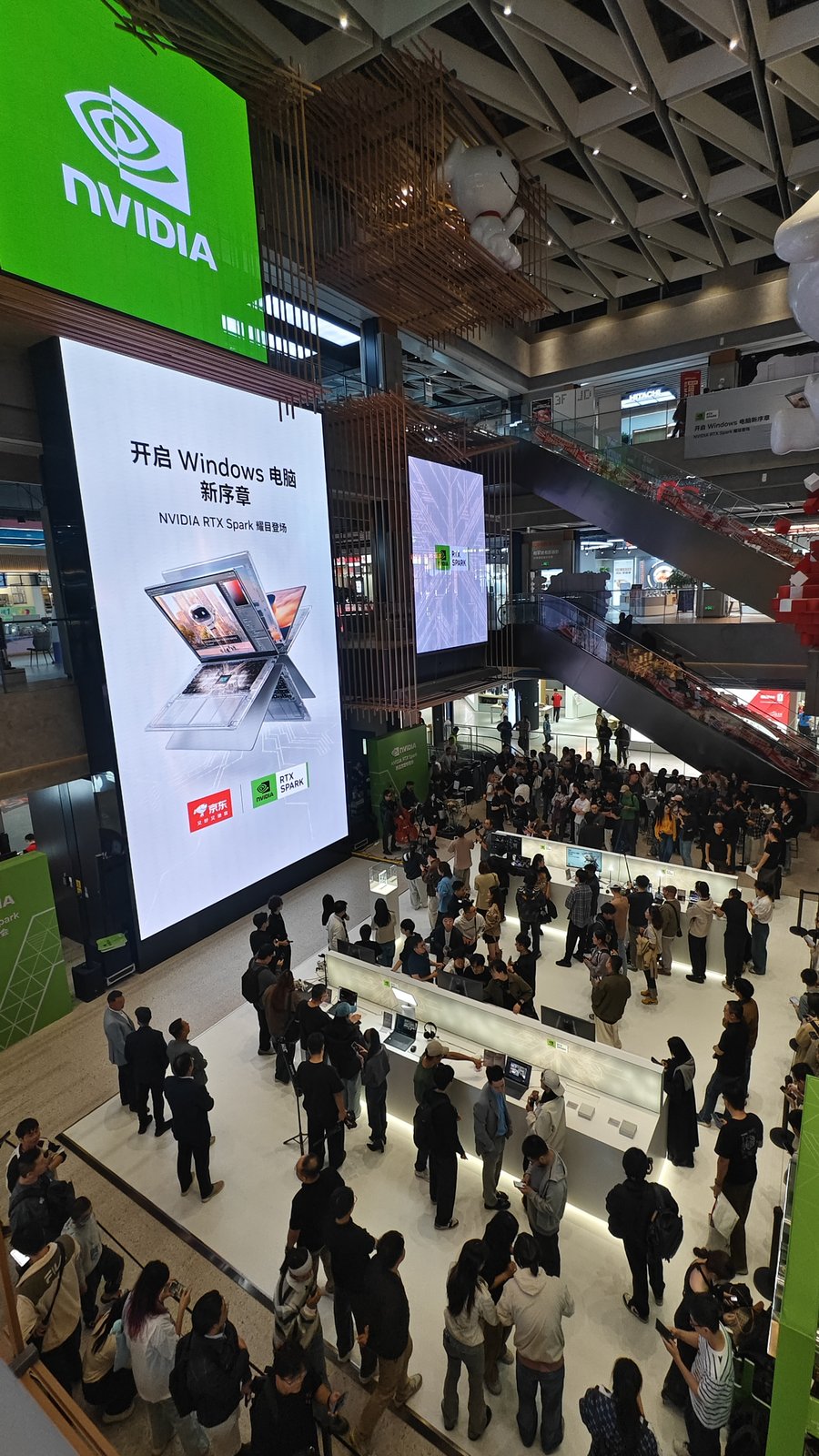 Crowd and demo stations under a large NVIDIA RTX Spark LED screen at JD MALL Beijing Shuangjing